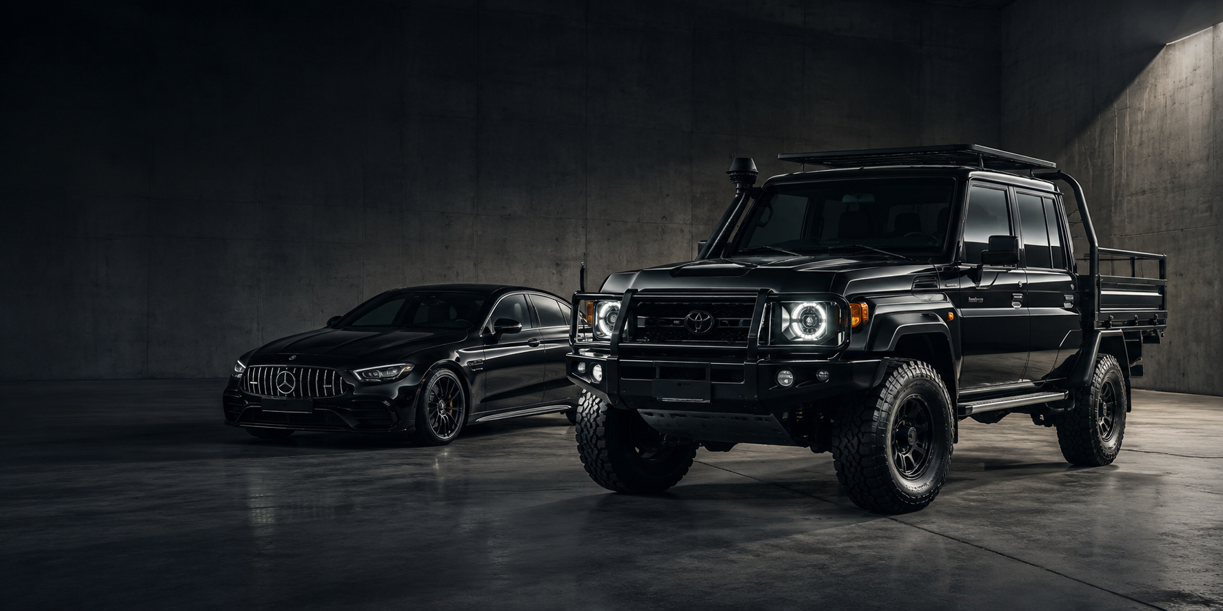 Black modified Toyota LandCruiser 79 Series and Mercedes-AMG in a premium automotive studio